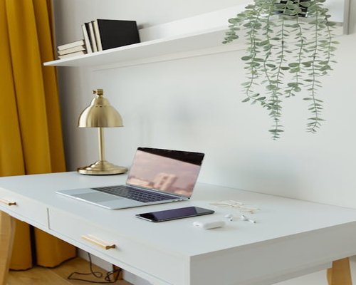 A neat modern office desk setup with a laptop
