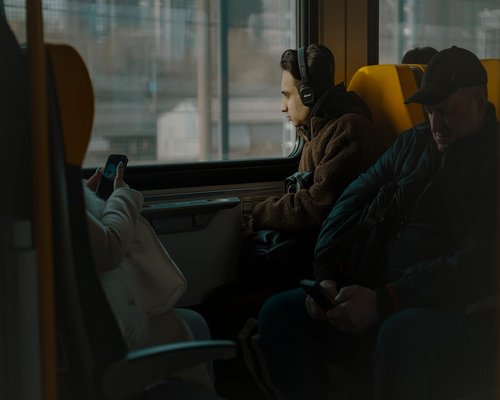 Person commuting while listening to music looking out window